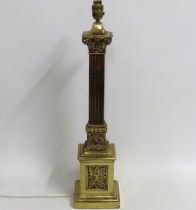 A large brass Greek Corinthian style lamp base fea