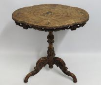A 19thC. walnut table with hunting scene decor, wi