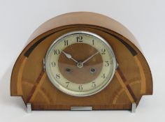 An art deco mantle clock with inlaid decor, fault