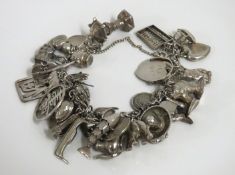 A silver charm bracelet with approx. 30 charms inc