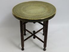 A Benares table with embossed brass top, 590mm hig