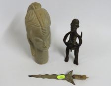 A Benin bronze figure of naked warrior, a white me