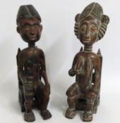 A pair of African tribal art carved figures depict