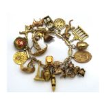 A 9ct gold charm bracelet including at least one 1