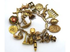 A 9ct gold charm bracelet including at least one 1