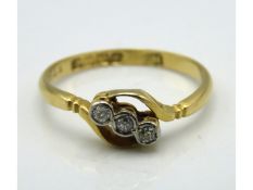 An 18ct gold antique ring set with three small dia