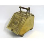 A brass coal scuttle & scoop with embossed decorat