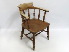 A 19thC. elm smokers bow chair, damage to left fac