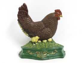 A painted cast iron chicken, clutch of eggs & hatc