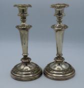 A pair of continental silver candlesticks, one det