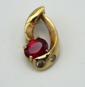 A 14ct gold pendant set with ruby & white stones,