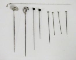 A selection of antique hat pins, some silver, long