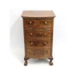 A walnut five drawer chest of drawers with ball &