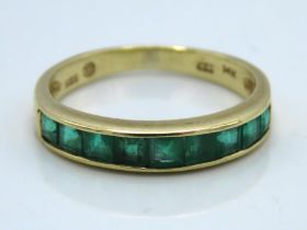 A 14ct gold half eternity ring set with emerald, 1