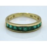 A 14ct gold half eternity ring set with emerald, 1