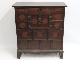 An Oriental cabinet with cupboard & four drawers,