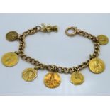 An 18ct gold chain with various Lourdes related ch