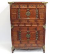 An Oriental three piece cabinet with base stand wi