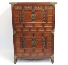 An Oriental three piece cabinet with base stand wi