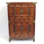 An Oriental three piece cabinet with base stand wi