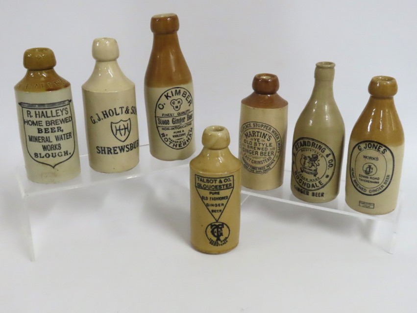 Seven stoneware ginger beer bottles including R. H