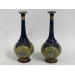 A pair of Doulton stoneware bottle vases with mask