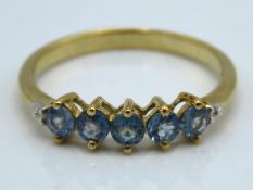 A 9ct gold ring set with five blue sapphires, 1.8g