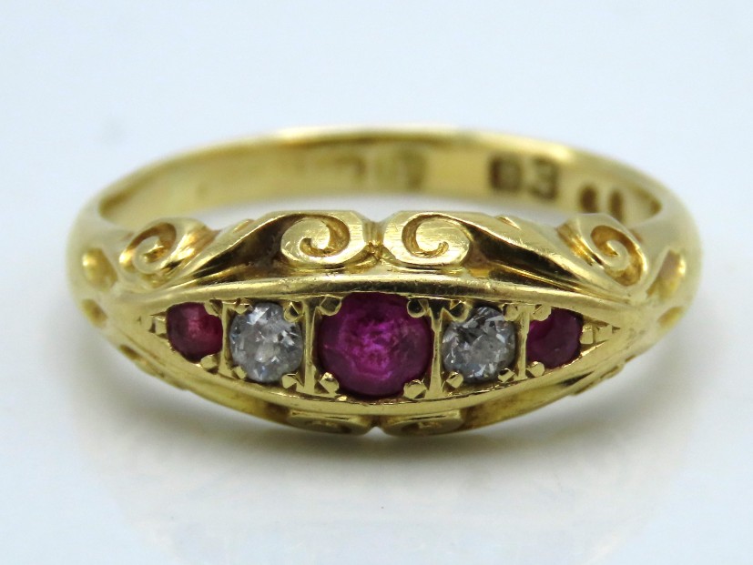 An antique 18ct gold ring with carved decor set wi