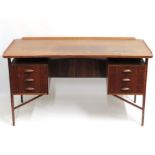 A mid 20thC. Danish rosewood curved desk with six