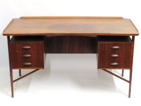 A mid 20thC. Danish rosewood curved desk with six