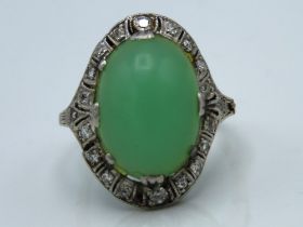 A white metal clip shank ring set with jade & diam