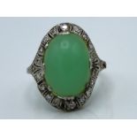 A white metal clip shank ring set with jade & diam