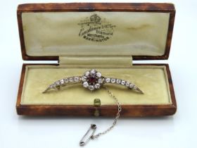 An antique bi-metal brooch set with central ruby o