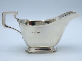 A 1914 Birmingham silver creamer of plain form by