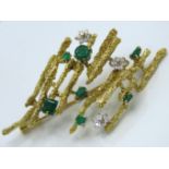 A 14ct gold brooch set with diamond & emerald, 64m