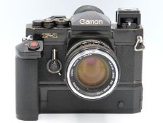 A Canon F-1 35mm film camera with manual along wit