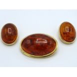 A pair of 9ct gold mounted clip on amber earrings,