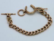 A yellow metal chain with T-bars & horseshoe clasp