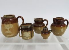 Four miniature Doulton stoneware jugs & one simila