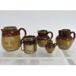 Four miniature Doulton stoneware jugs & one simila