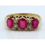 An 18ct gold ring set with ruby & diamond, centre