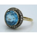 An 18ct gold ring set with aquamarine & 24 small r