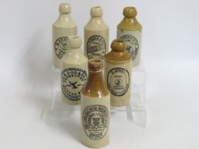 Six stoneware ginger beer bottles including R. M. Bird, Stratford on Avon, G. Jones, Twickenham & Th