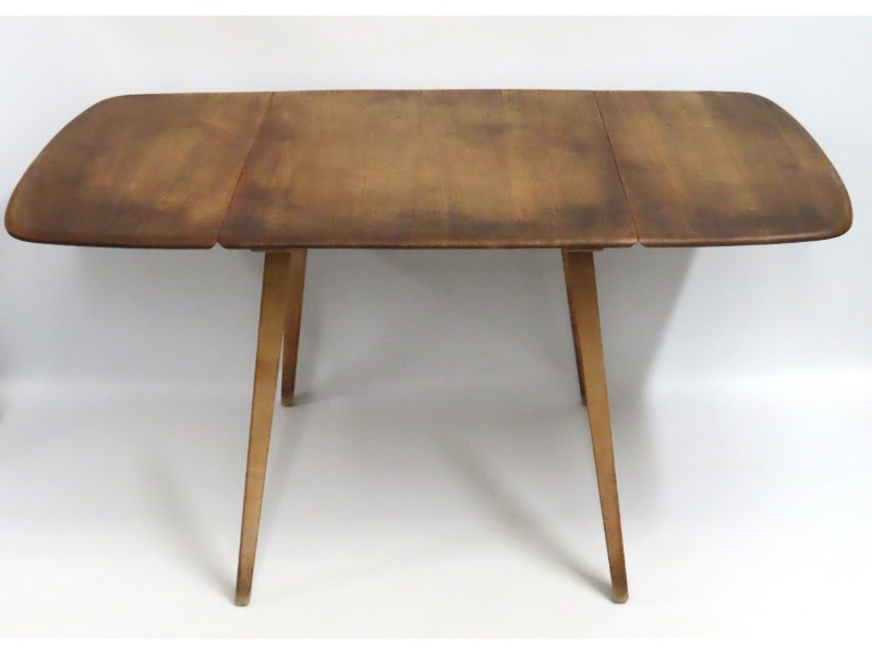 A mid 20thC. Ercol 383 drop leaf elm table, 1385mm