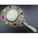 An antique Chinese jade & silver on copper mounted mirror with belt hook handle set with semi precio