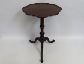 A 19thC. mahogany wine table with scalloped edge,