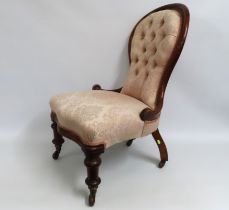 A late Victorian button back salon chair in pink u