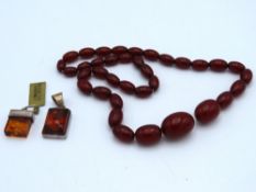 A red amber style necklace, 25.3g twinned with sil