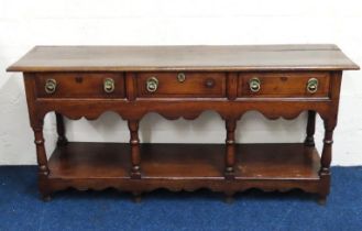 An 18thC. oak dresser base, lacks one drawer pull,