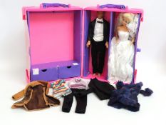 A Barbie set with case, clothes & two figures